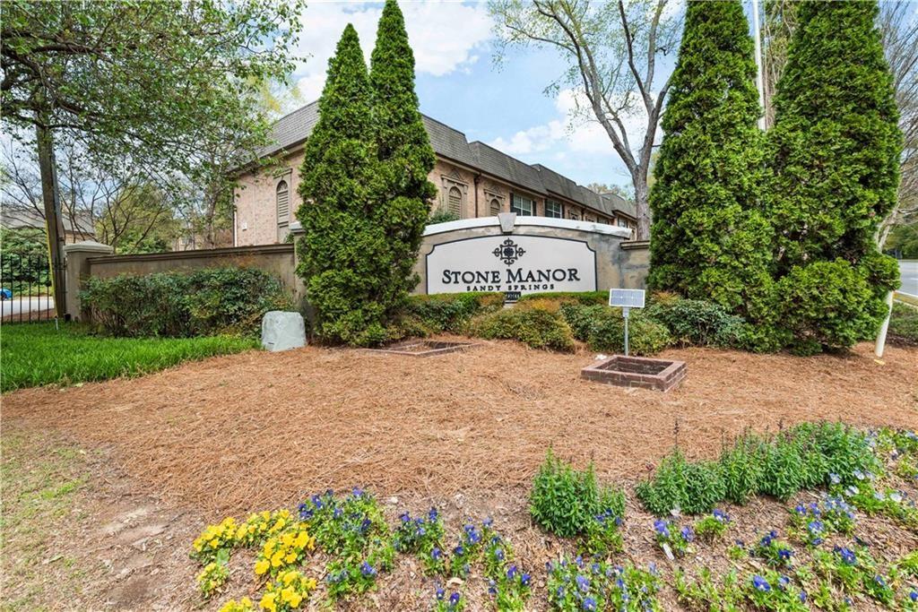 6980 Roswell Road, Unit P2 Atlanta, GA 30328 - Photo 1 of 1 a front view of a house with a yard and a garage