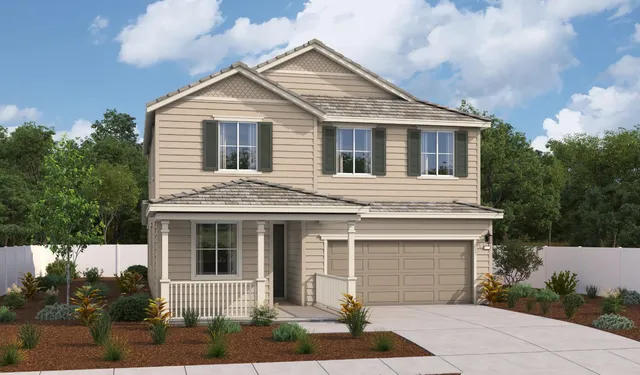 a front view of a house with a garden and plants