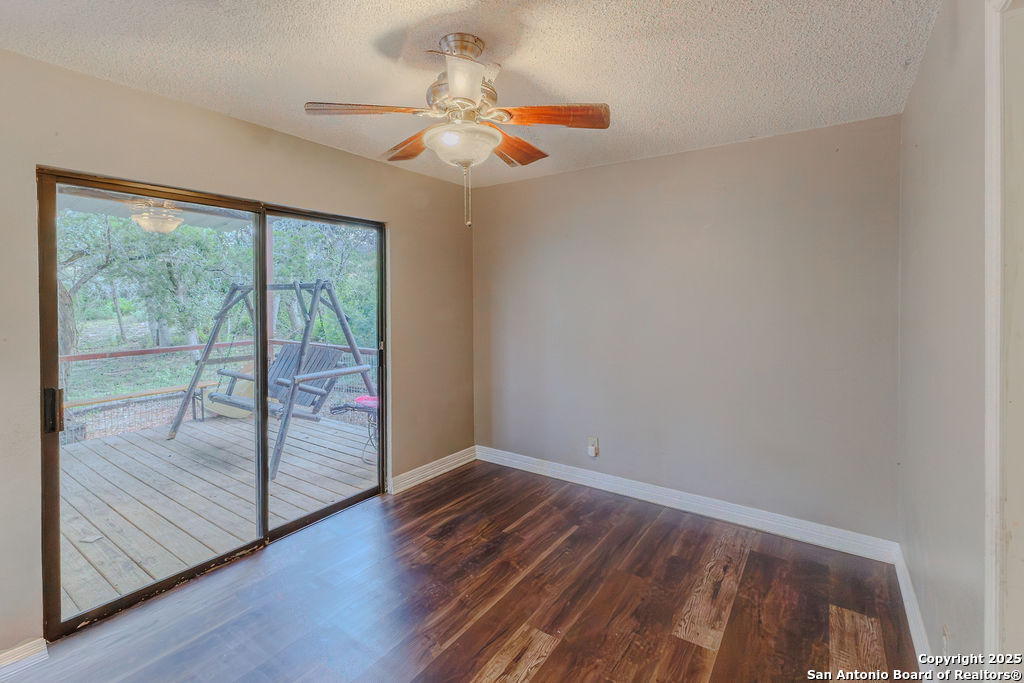 744 County Road 2651 Rio Medina, TX 78066 - Photo 14 of 29 a view of an empty room with wooden floor and a window