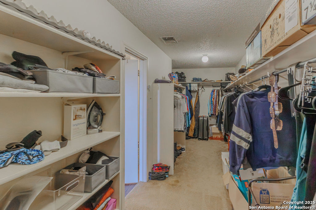 744 County Road 2651 Rio Medina, TX 78066 - Photo 16 of 27 a view of walk in closet with clothes and shoes