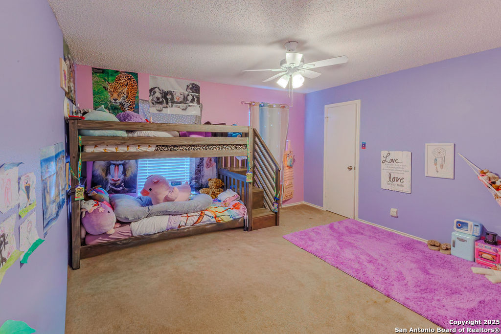 744 County Road 2651 Rio Medina, TX 78066 - Photo 19 of 27 a bedroom with bed and chandelier