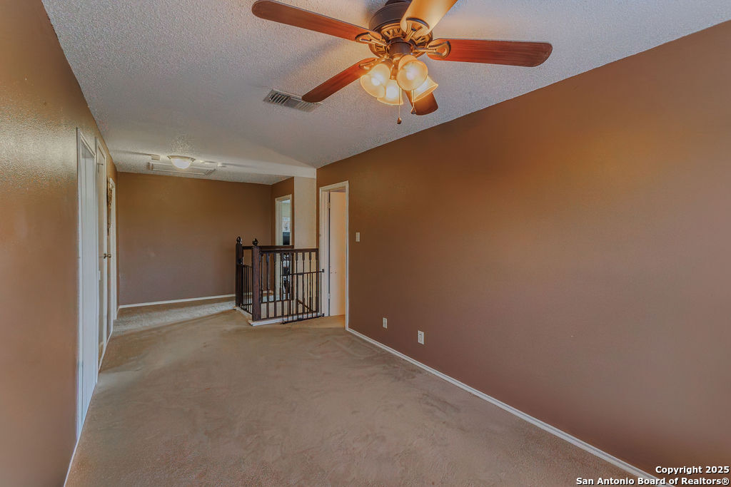 744 County Road 2651 Rio Medina, TX 78066 - Photo 20 of 29 an empty room with windows and fan