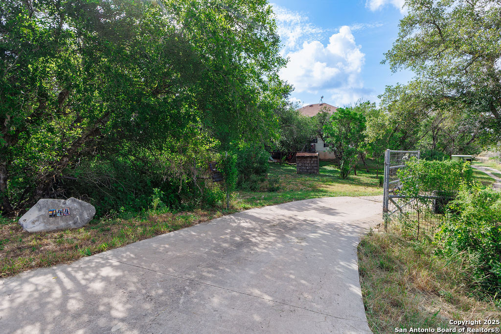 744 County Road 2651 Rio Medina, TX 78066 - Photo 20 of 27 a view of a street with a tree in the background