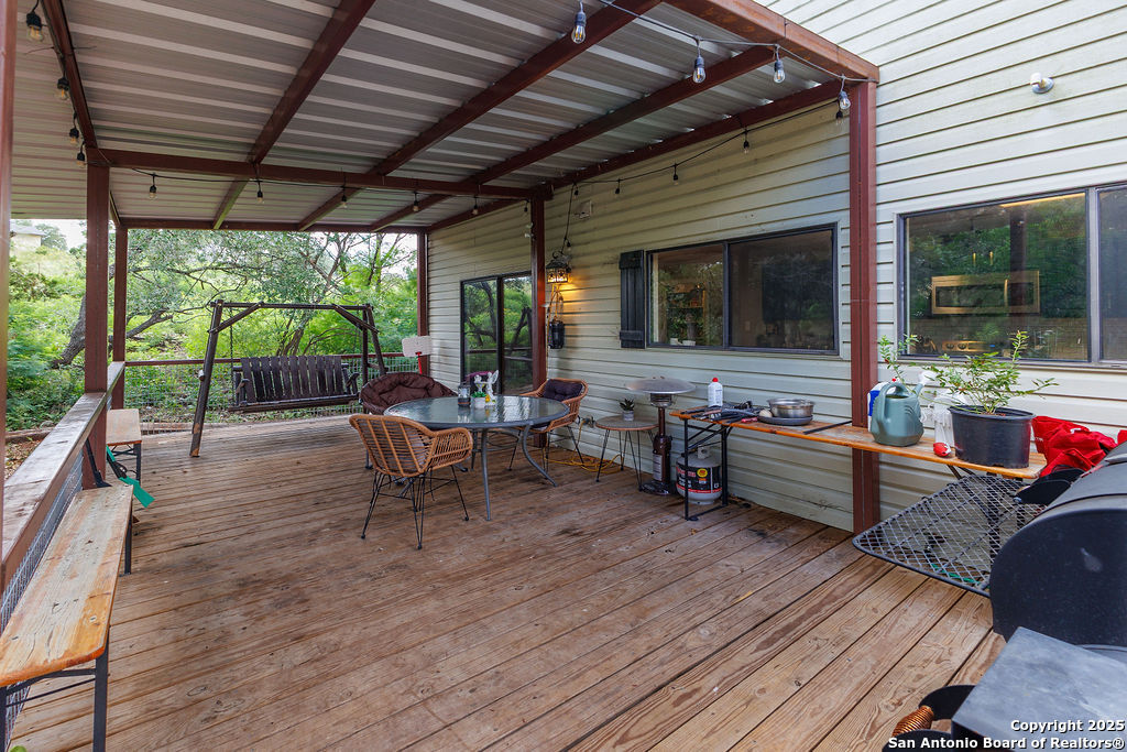 744 County Road 2651 Rio Medina, TX 78066 - Photo 25 of 27 a outdoor space with patio the couches and a dining table with the garden view