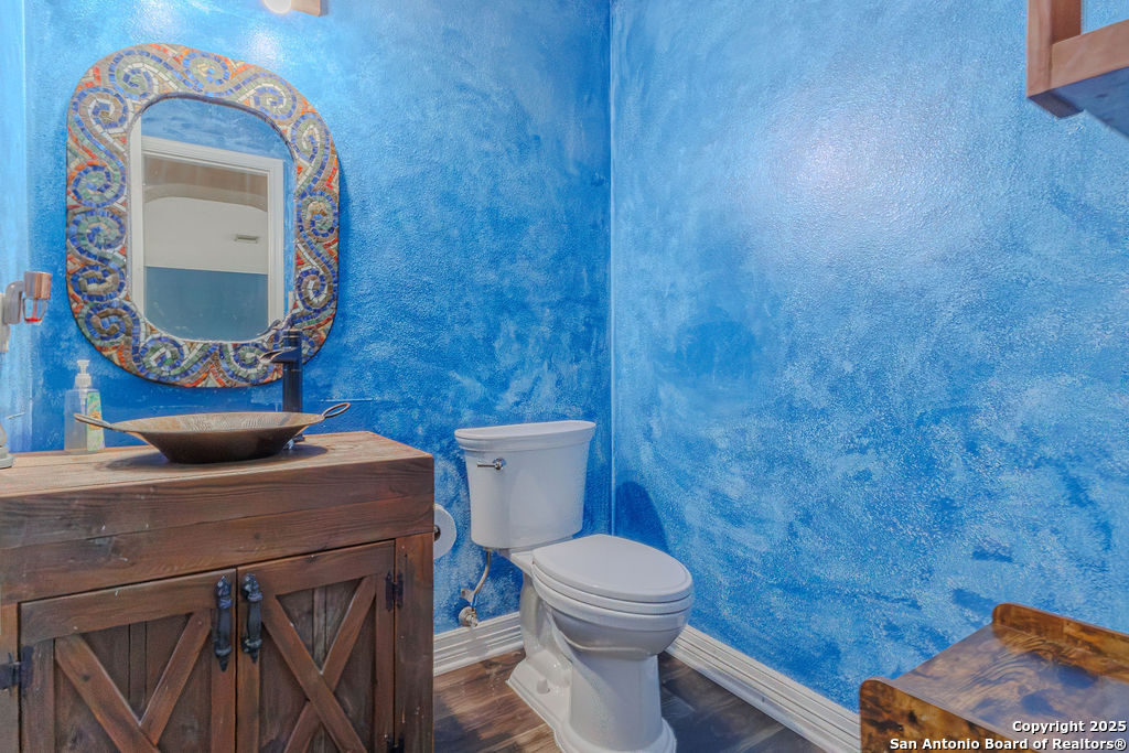744 County Road 2651 Rio Medina, TX 78066 - Photo 7 of 27 a bathroom with a toilet mirror vanity and toilet