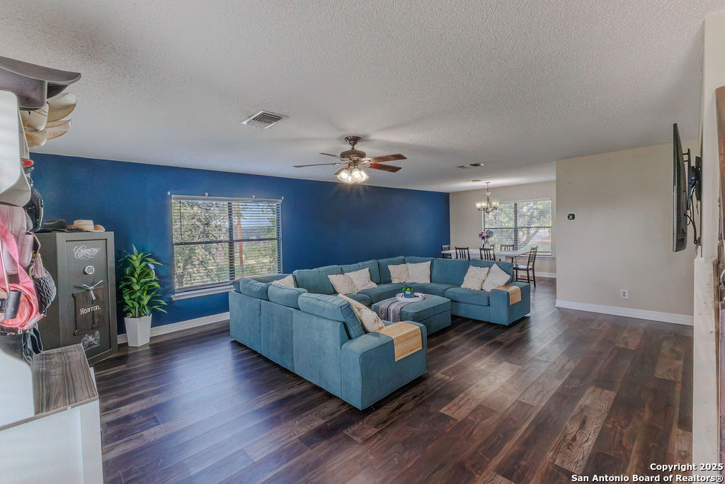 744 County Road 2651 Rio Medina, TX 78066 - Photo 8 of 29 a living room with furniture and a flat screen tv