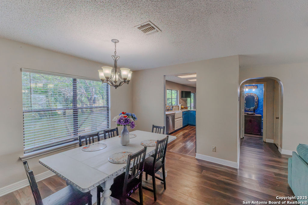 744 County Road 2651 Rio Medina, TX 78066 - Photo 10 of 29 a view of a dining room with furniture window and wooden floor