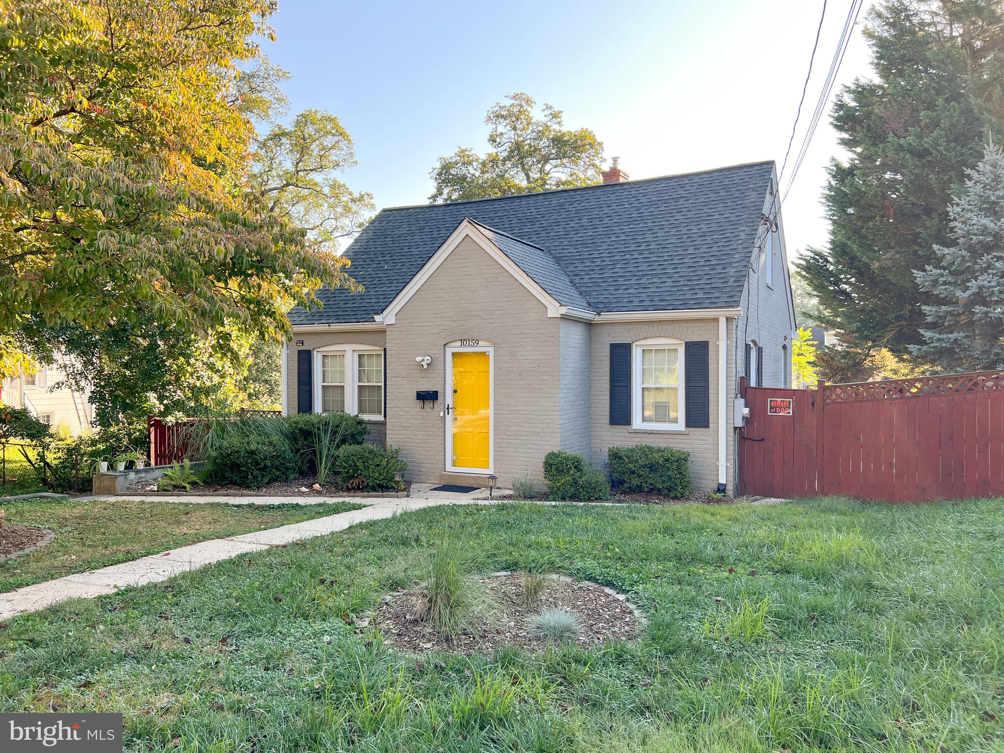 10159 Sutherland Road Silver Spring, MD 20901 - Photo 1 of 30 a front view of a house with a yard and garage