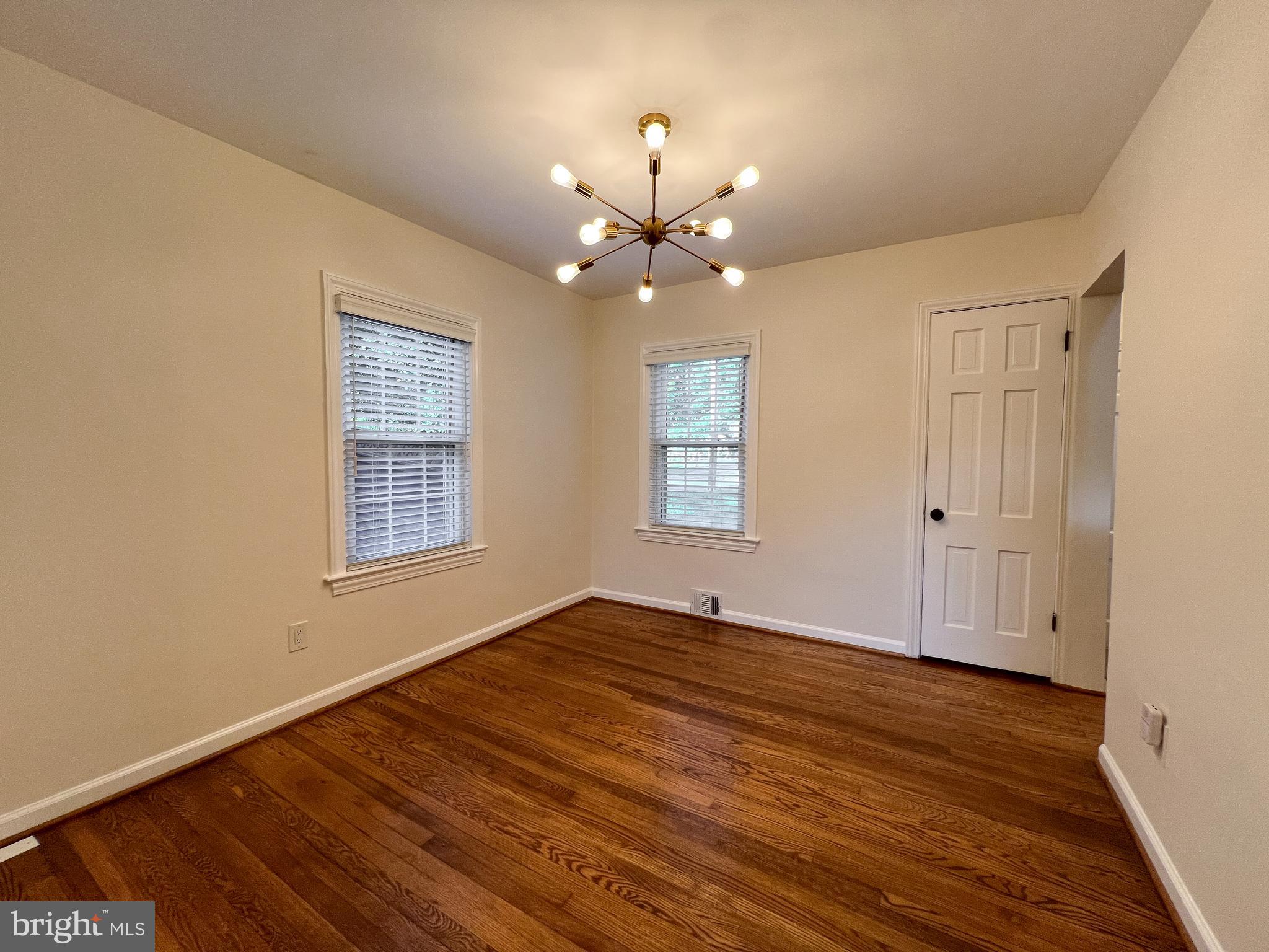 10159 Sutherland Road Silver Spring, MD 20901 - Photo 11 of 30 a view of an empty room with a window and wooden floor