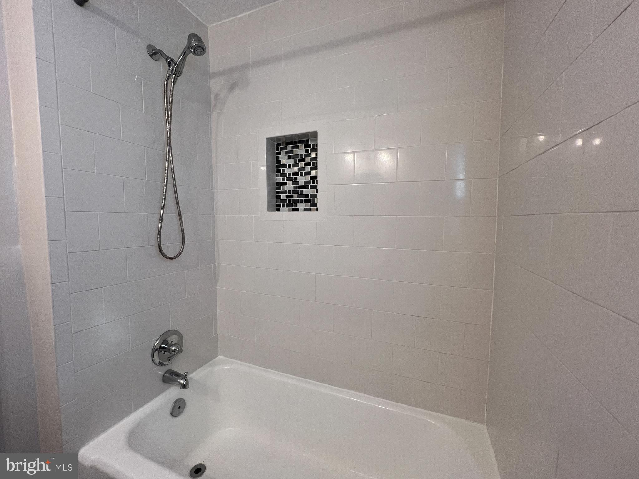 10159 Sutherland Road Silver Spring, MD 20901 - Photo 19 of 30 a bathroom with a bath tub and a shower