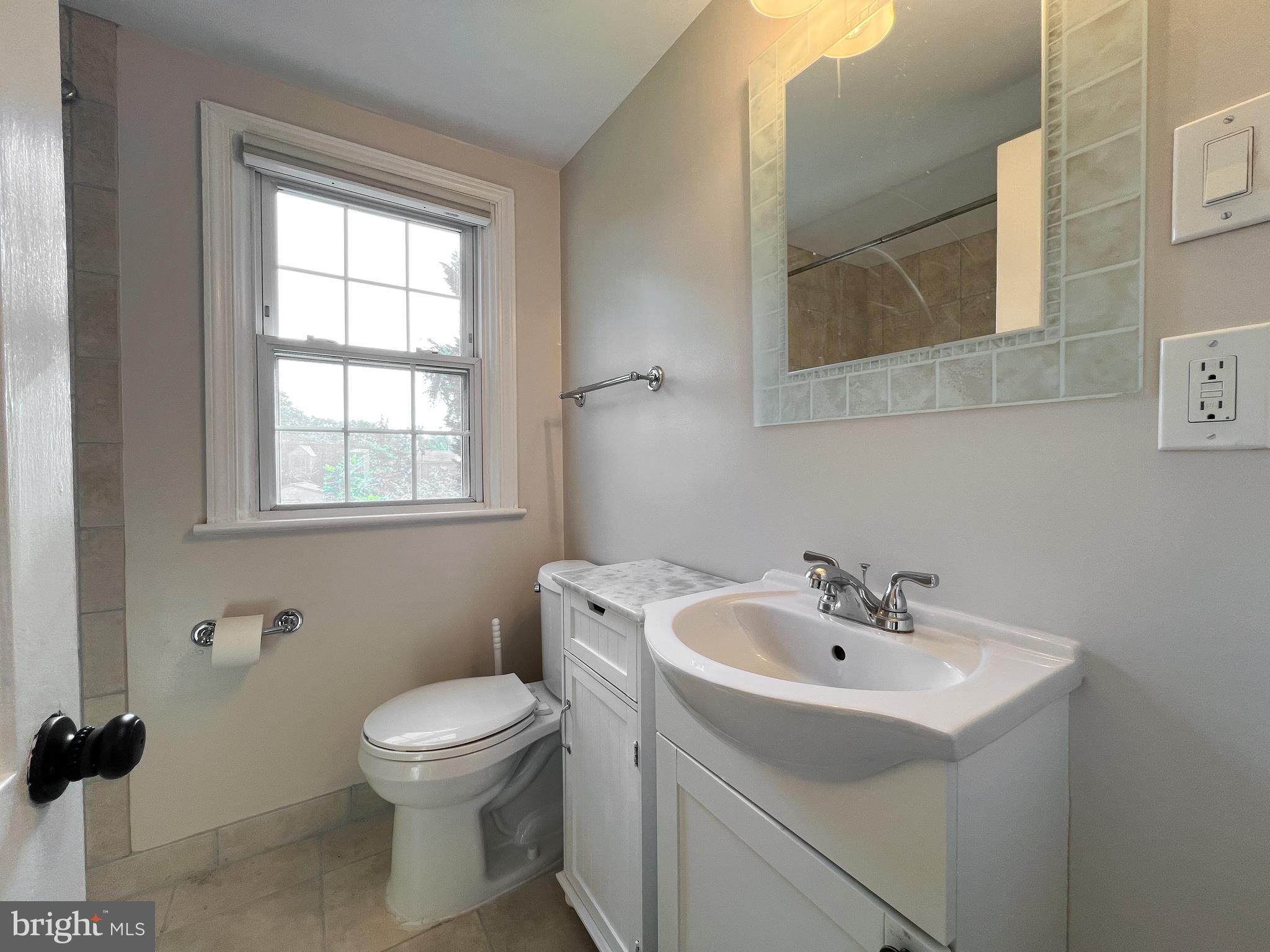 10159 Sutherland Road Silver Spring, MD 20901 - Photo 23 of 30 a bathroom with a sink a toilet and a mirror
