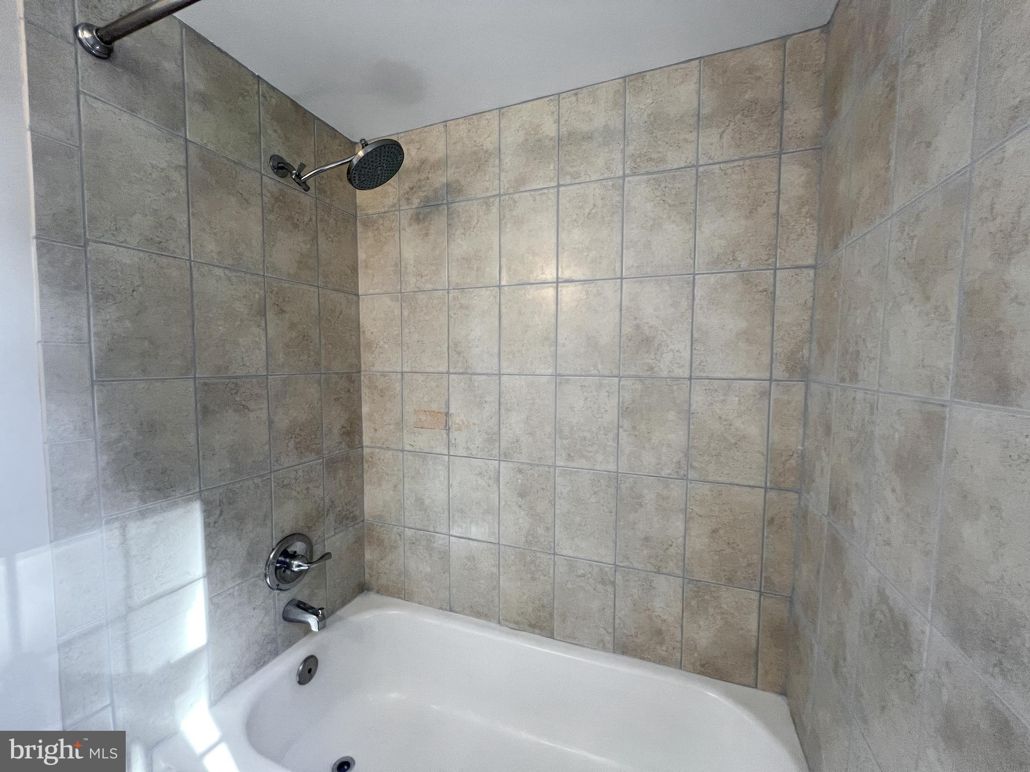 10159 Sutherland Road Silver Spring, MD 20901 - Photo 24 of 30 a bathroom with a bathtub and a shower