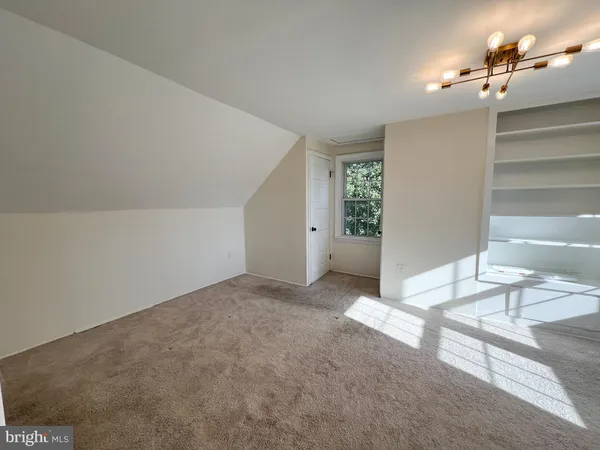 a view of a livingroom and a bathroom with bathtub