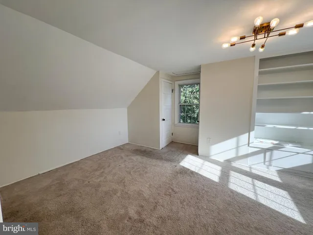 a view of a livingroom and a bathroom with bathtub
