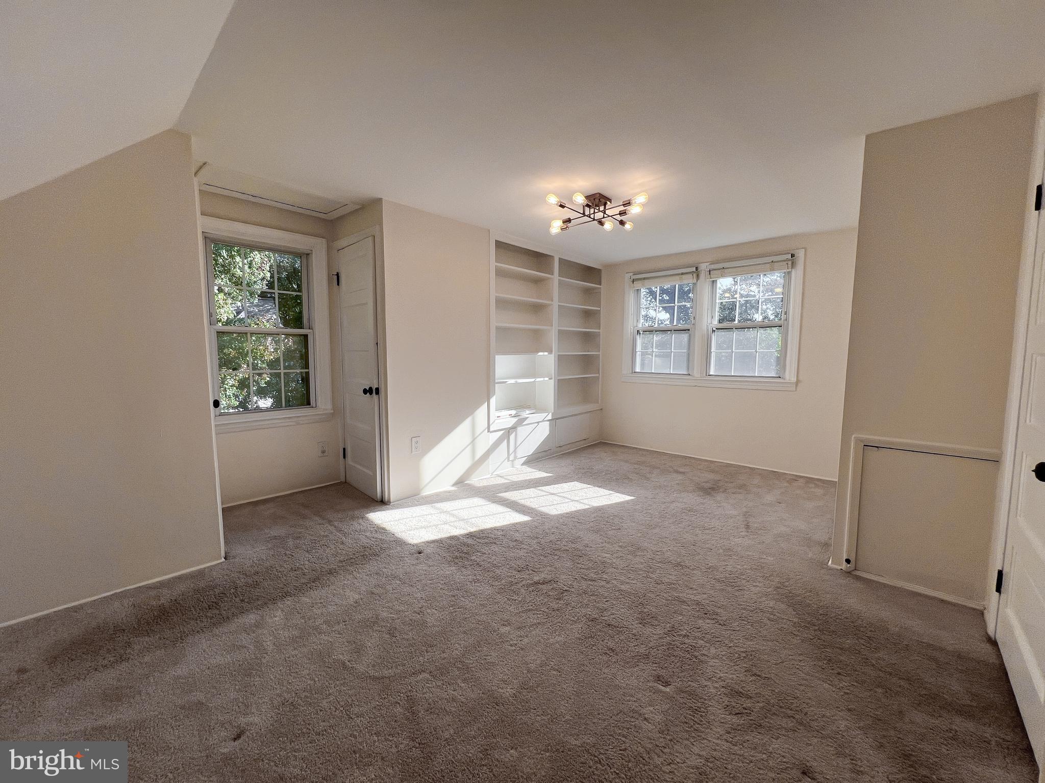 10159 Sutherland Road Silver Spring, MD 20901 - Photo 26 of 30 a view of empty room with windows and chandelier fan