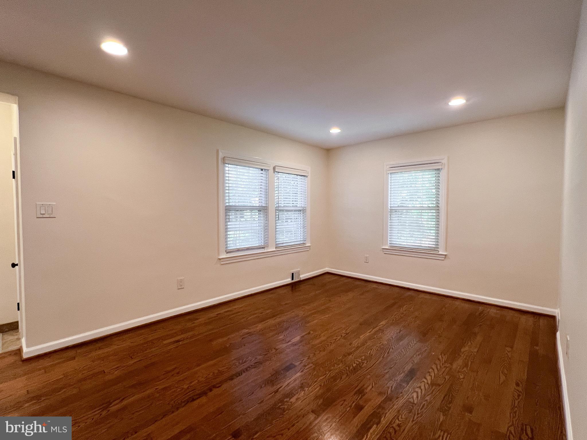 10159 Sutherland Road Silver Spring, MD 20901 - Photo 7 of 30 an empty room with wooden floor and windows