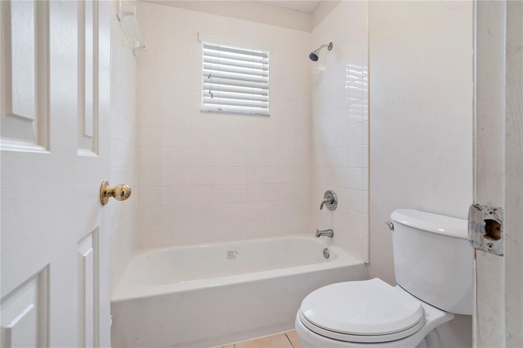 565 Pinehurst Cove Kissimmee, FL 34758 - Photo 14 of 36 a white bath tub sitting next to a white toilet
