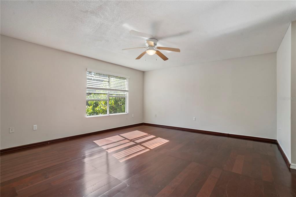 565 Pinehurst Cove Kissimmee, FL 34758 - Photo 20 of 36 an empty room with windows and fan