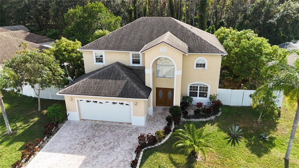 565 Pinehurst Cove Kissimmee, FL 34758 - Photo 32 of 36 a front view of house with garden