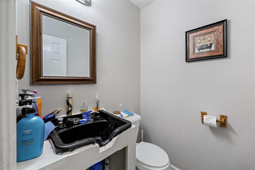 248 Springbottom Drive Southeast Lawrenceville, GA 30046 - Photo 13 of 32 a bathroom with a toilet a sink and mirror