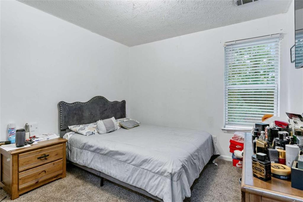 248 Springbottom Drive Southeast Lawrenceville, GA 30046 - Photo 20 of 32 a bedroom with bed and window