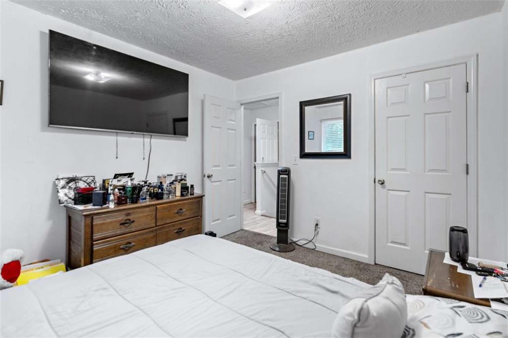 248 Springbottom Drive Southeast Lawrenceville, GA 30046 - Photo 21 of 32 a bedroom with a bed and a flat screen tv
