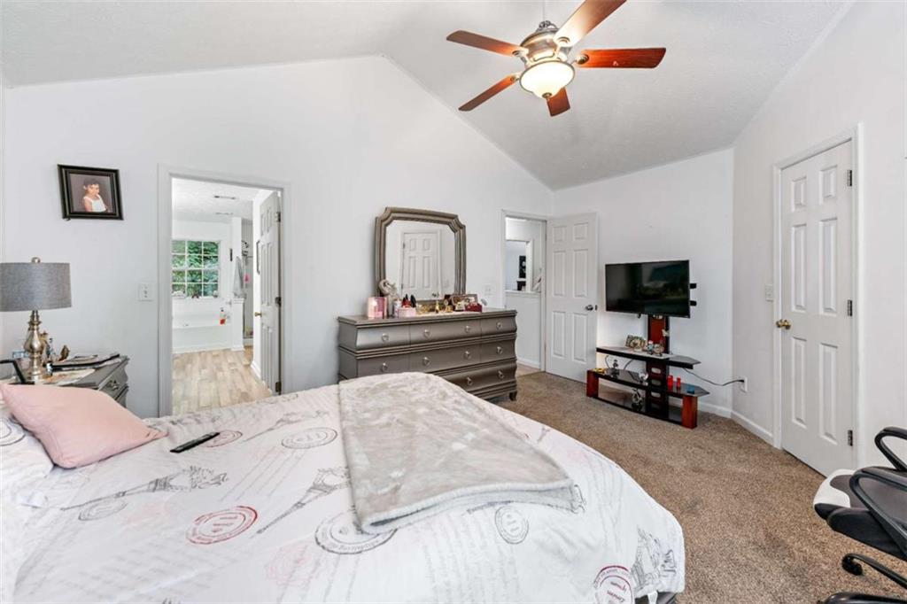 248 Springbottom Drive Southeast Lawrenceville, GA 30046 - Photo 23 of 32 a bedroom with a bed and a flat screen tv