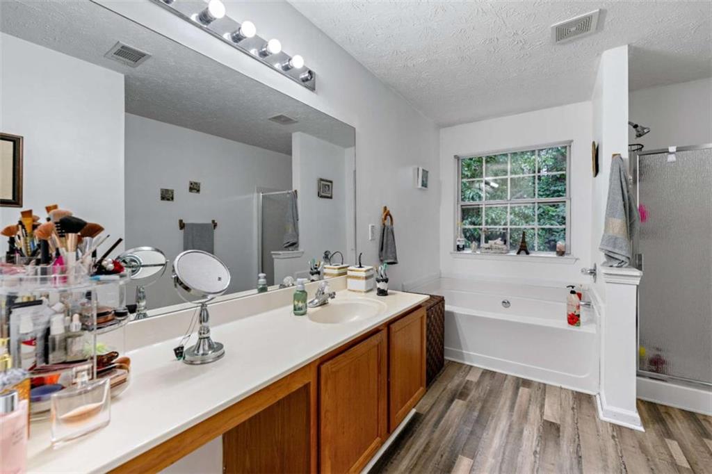 248 Springbottom Drive Southeast Lawrenceville, GA 30046 - Photo 24 of 32 a bathroom with a tub sink and mirror