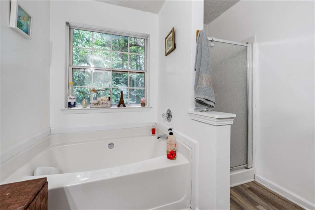 248 Springbottom Drive Southeast Lawrenceville, GA 30046 - Photo 25 of 32 a bathroom with a bathtub a window and a shower