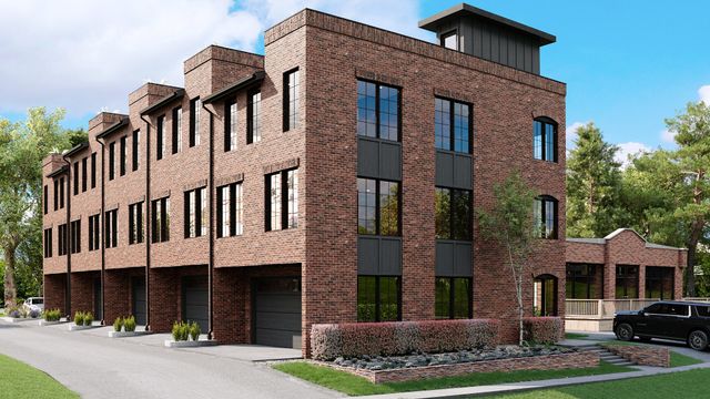 a front view of a residential apartment building with a yard