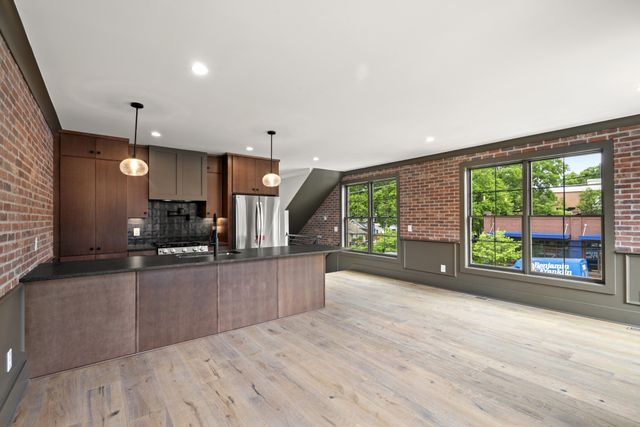 an empty room with wooden floor and outdoor view