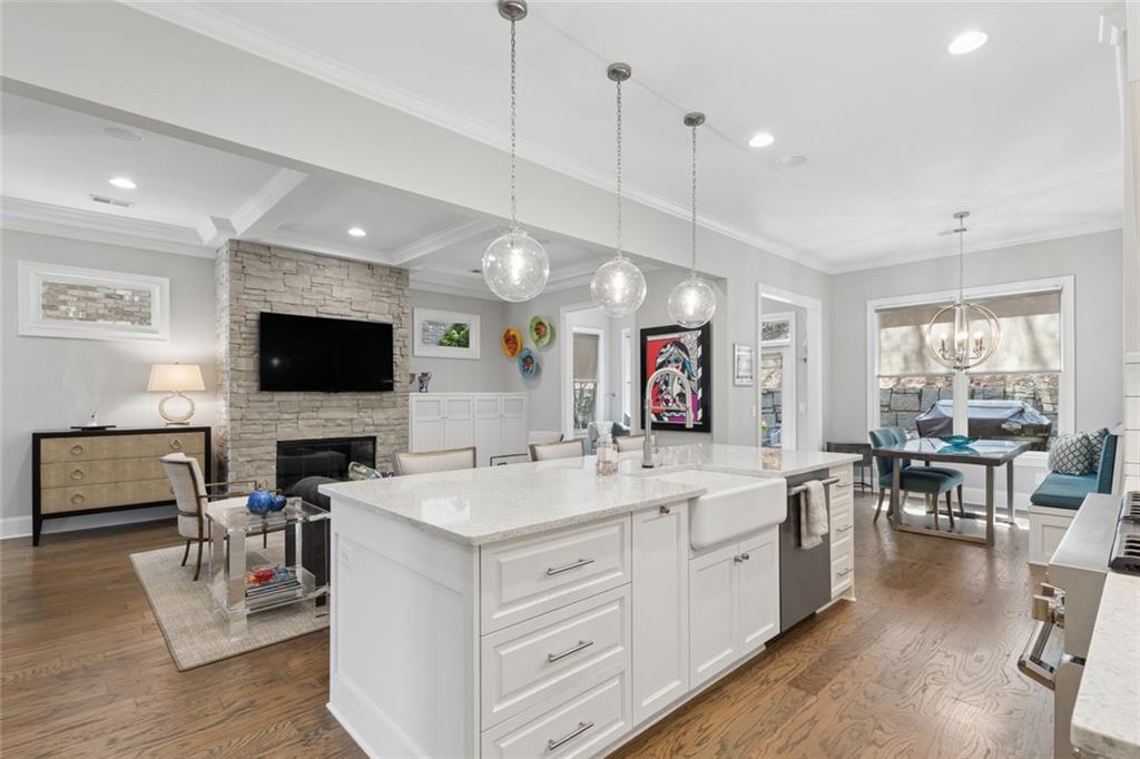 317 Riversedge Drive Atlanta, GA 30339 - Photo 18 of 68 a large white kitchen with a large island in the center a fireplace stainless steel appliances and a window