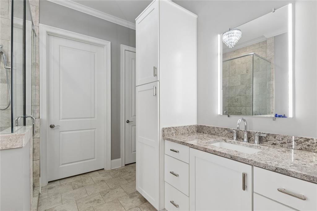 317 Riversedge Drive Atlanta, GA 30339 - Photo 30 of 68 a bathroom with a granite countertop sink and a mirror