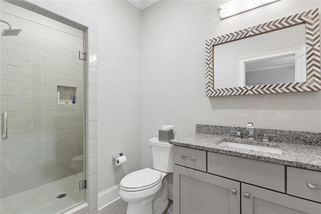 317 Riversedge Drive Atlanta, GA 30339 - Photo 36 of 68 a bathroom with a granite countertop sink a mirror and a shower