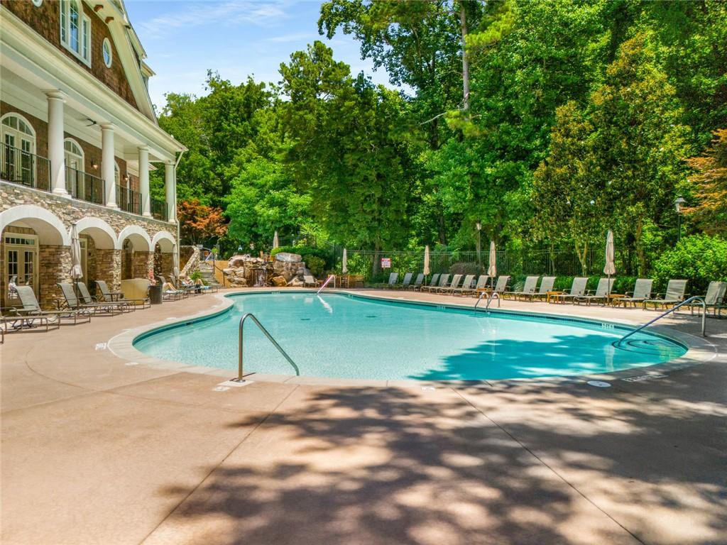 317 Riversedge Drive Atlanta, GA 30339 - Photo 49 of 68 a view of a swimming pool with a bench in front of a house