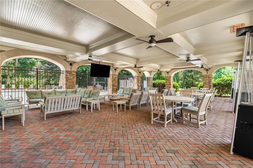 317 Riversedge Drive Atlanta, GA 30339 - Photo 50 of 68 a outdoor space with lots of tables a large window and a couch