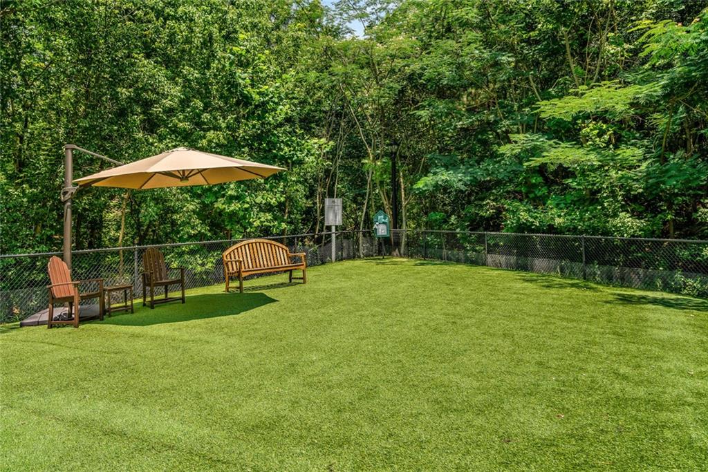 317 Riversedge Drive Atlanta, GA 30339 - Photo 62 of 68 a backyard of a house with table and chairs