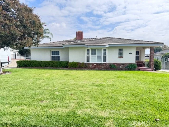 a front view of house with yard and green space