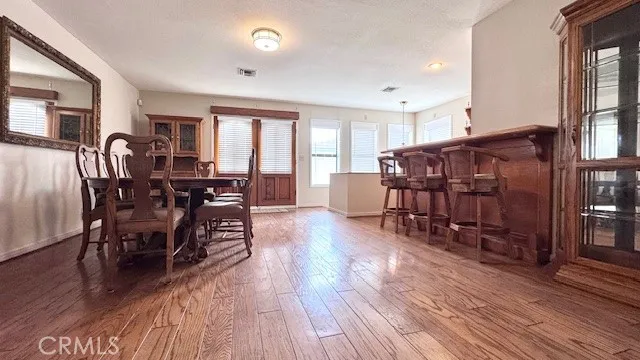 a view of a dining room with furniture window and wooden floor