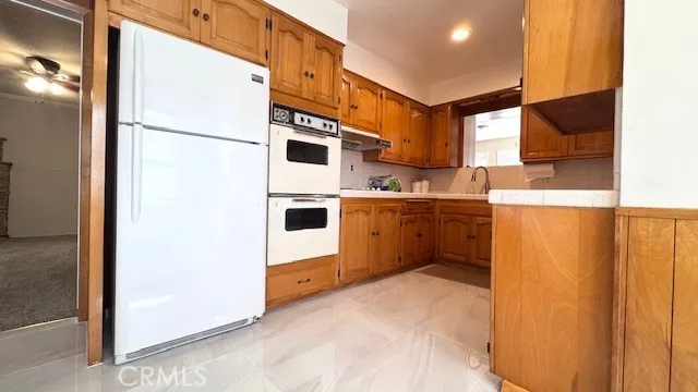 a kitchen with stainless steel appliances a refrigerator sink and cabinets