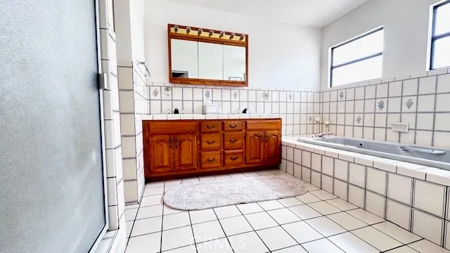 a bathroom with a bathtub and next to a window