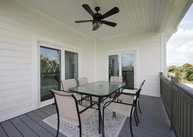 a view of a dining room with furniture and front door