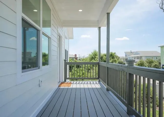 a view of a balcony with wooden floor