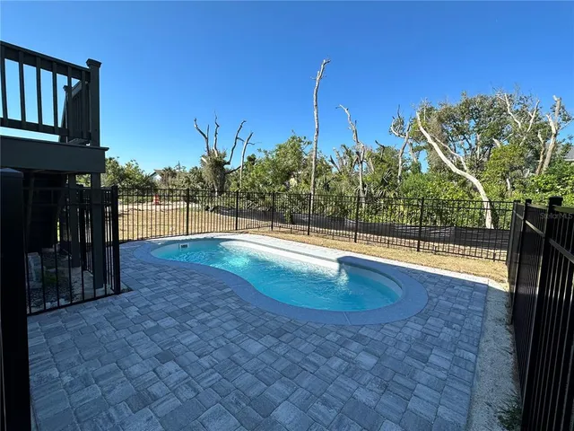 a view of a swimming pool with a patio