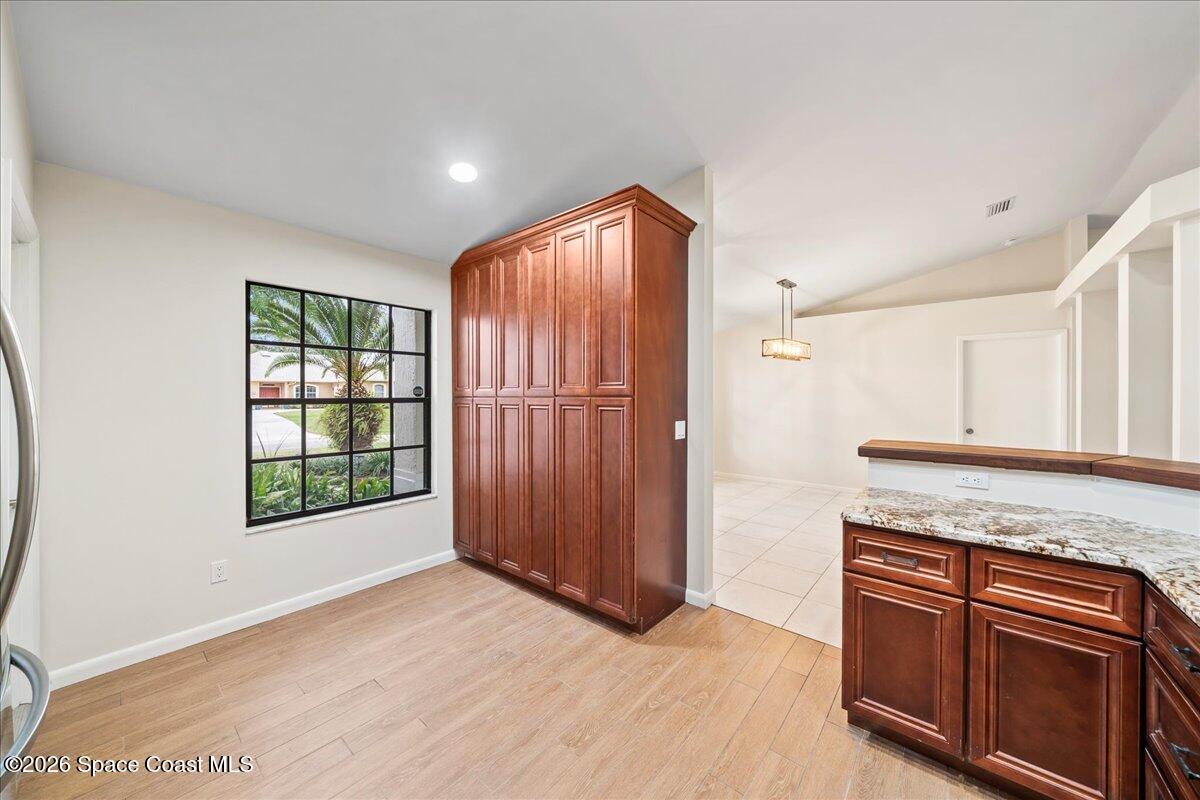 189 Abeto Terrace Sebastian, FL 32958 - Photo 12 of 38 an empty room with windows cabinet and front door