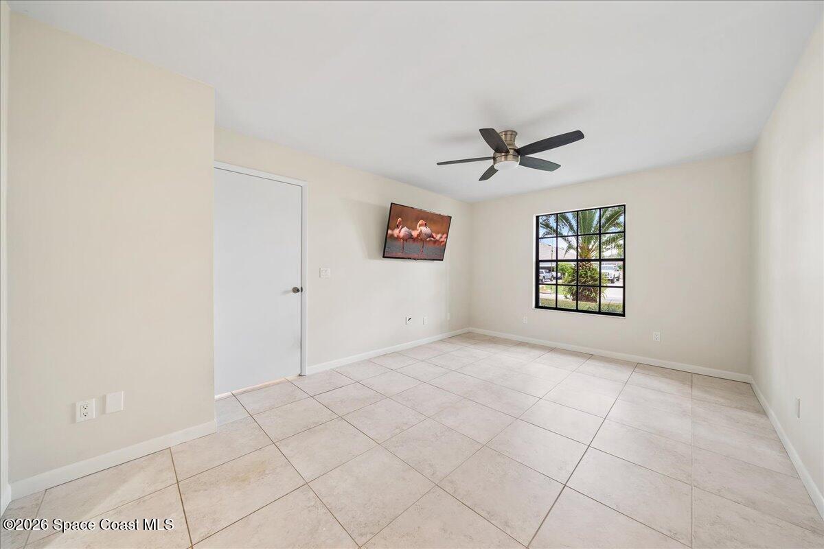 189 Abeto Terrace Sebastian, FL 32958 - Photo 16 of 38 an empty room with windows and ceiling fan
