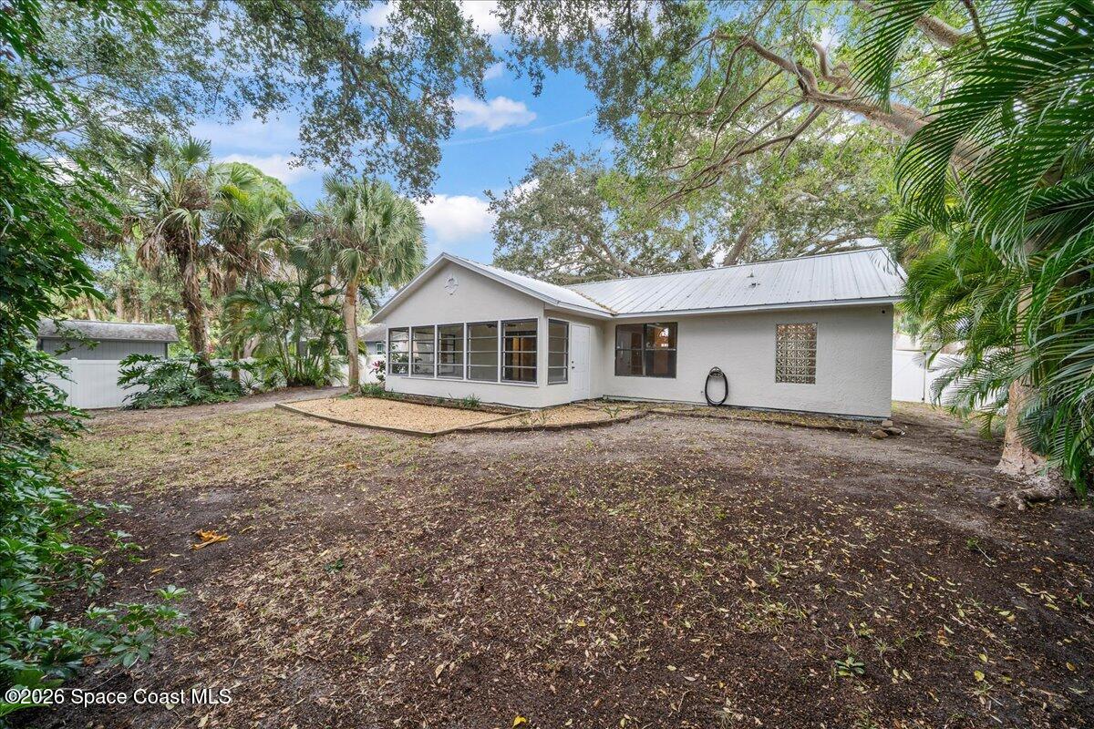 189 Abeto Terrace Sebastian, FL 32958 - Photo 27 of 38 a house with trees in the background