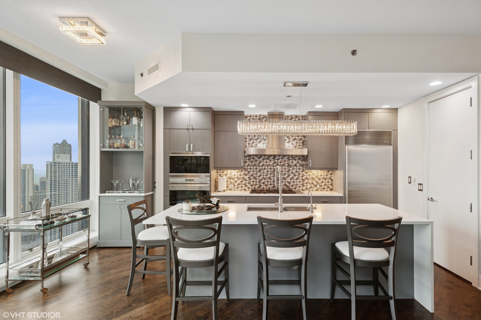 401 North Wabash Avenue, Unit 44F Chicago, IL 60611 - Photo 11 of 26 a kitchen with stainless steel appliances kitchen island granite countertop a dining table chairs and view living room