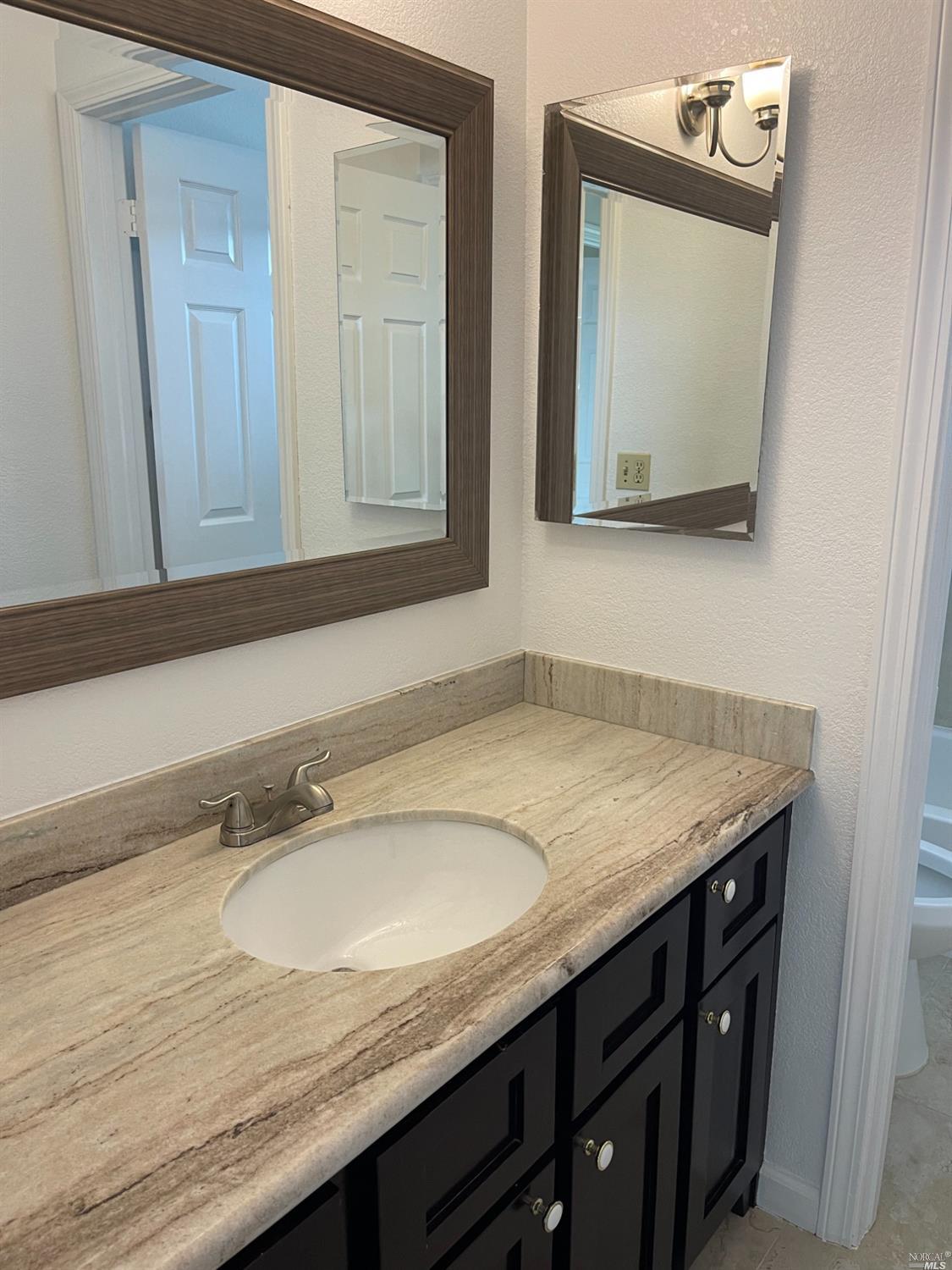 431 Darley Drive Vallejo, CA 94591 - Photo 23 of 27 a bathroom with a granite countertop sink and a mirror