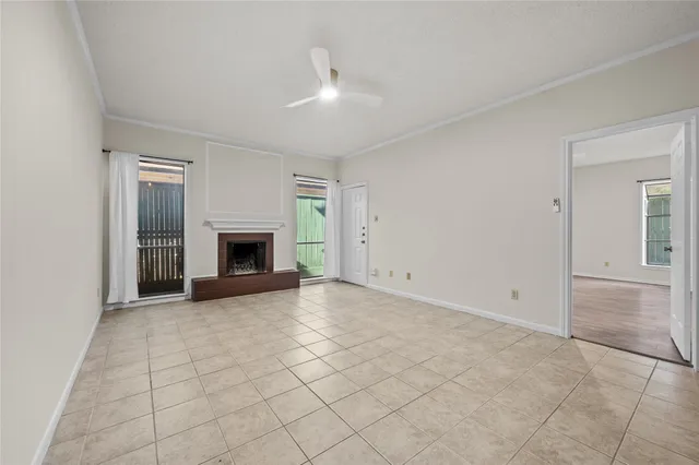 an empty room with fireplace and a window